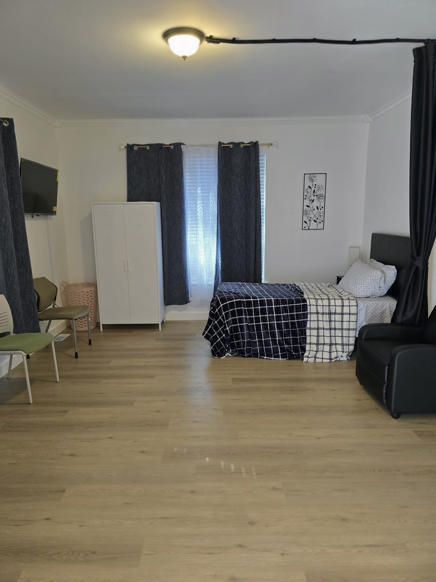 Resident bedroom with recliner and natural light
